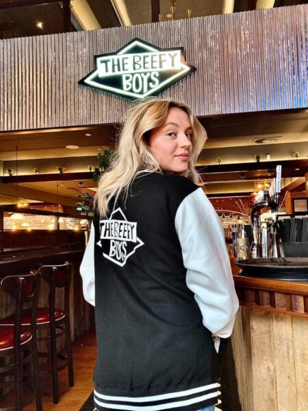 Black and white, adult Beefy Boys Leatherman jacket, back view, modelled by Ellie Goulding