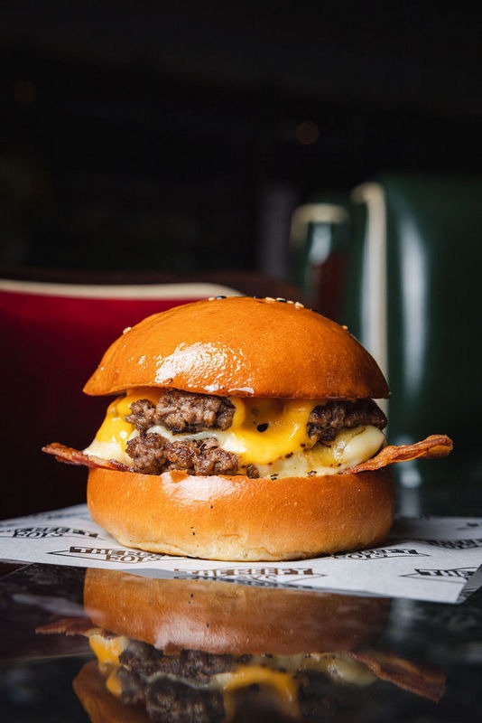 Stripped of extras, it showcases the pure essence of a great burger—just meat, cheese, bacon, and a bun. For those who prefer it even more classic, we offer the Basic Boy with American cheese.