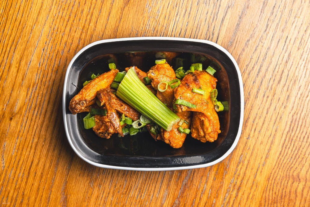 Our tender wings are drenched in spicy buffalo sauce, served with a side of refreshing Blue Cheese Dip, celery sticks, and spring onion.