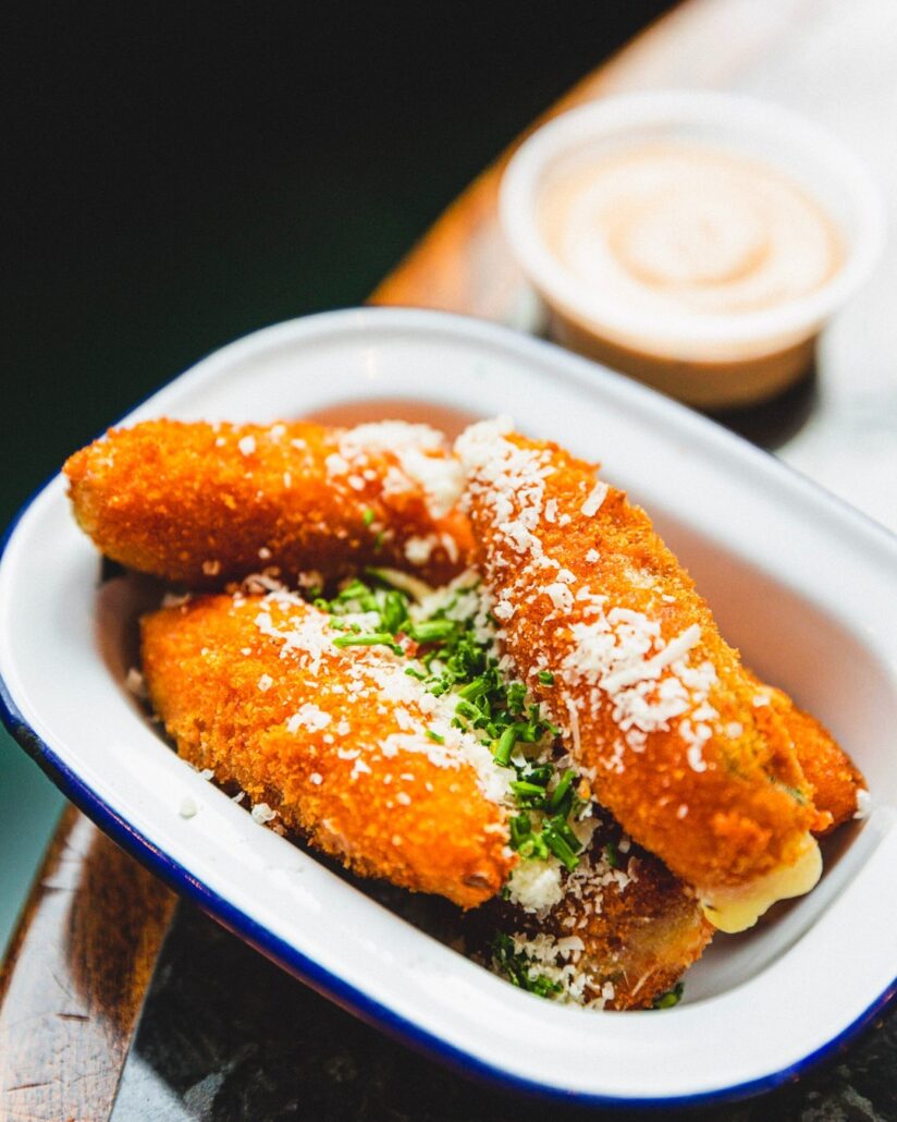 Our Jalapeño Poppers are crispy and golden on the outside, these delightful poppers are filled with a creamy blend of Parmesan and chives, accompanied by a tangy Chipotle Mayo dipping sauce.