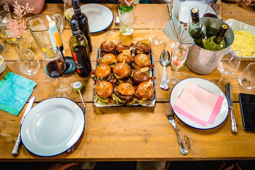 Wedding food on a table, with wine, burgers and beautiful cuttlery