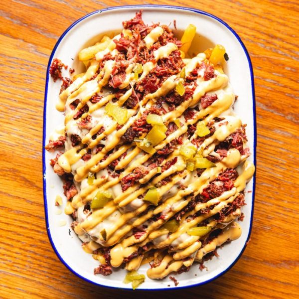 Photo of our Pastrami Fries! Generously loaded with smoked pastrami, double Swiss cheese, and a dollop of Dirty Mayo, these fries are a masterpiece of deliciousness.