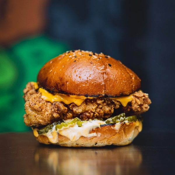 This chicken burger features double American cheese, gherkins, and Dirty Mayo