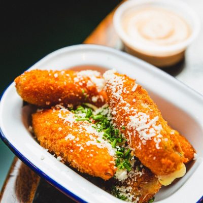 Our Jalapeño Poppers are crispy and golden on the outside, these delightful poppers are filled with a creamy blend of Parmesan and chives, accompanied by a tangy Chipotle Mayo dipping sauce.